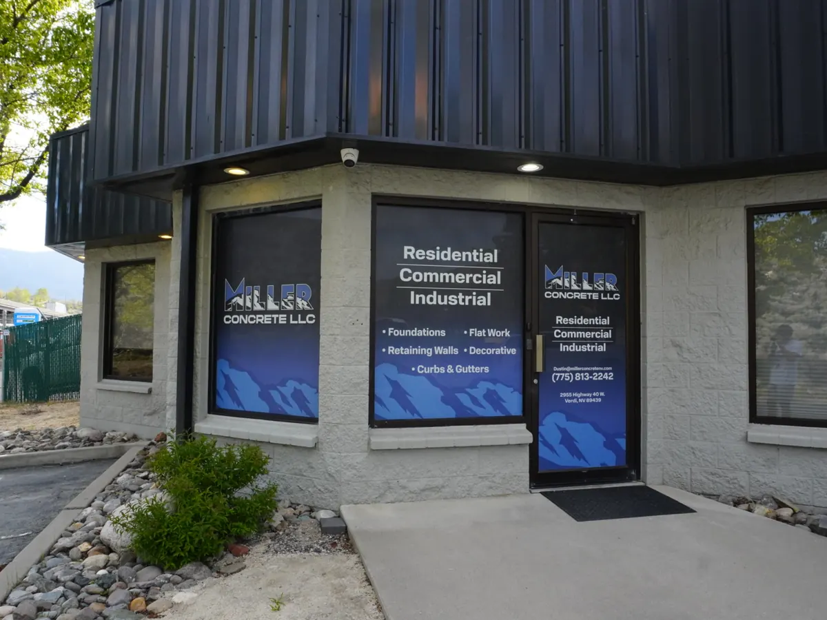 Miller Concrete office corner with blue printed graphics on every window and the front door